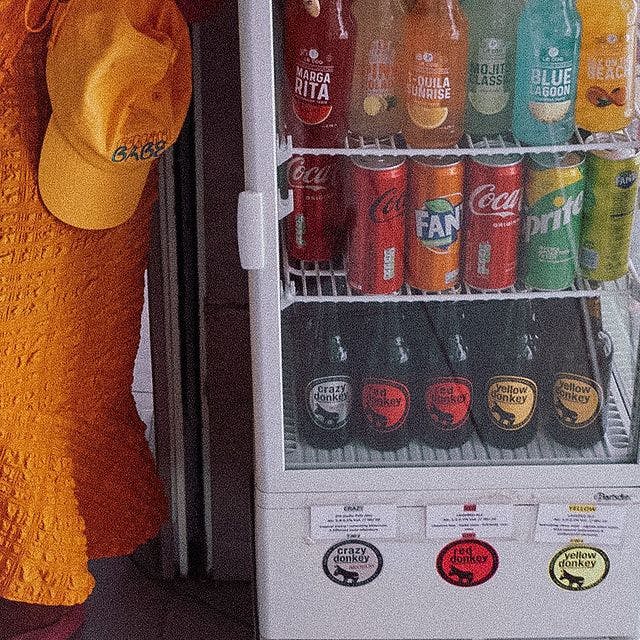 Belini cap hanging next to soda machine